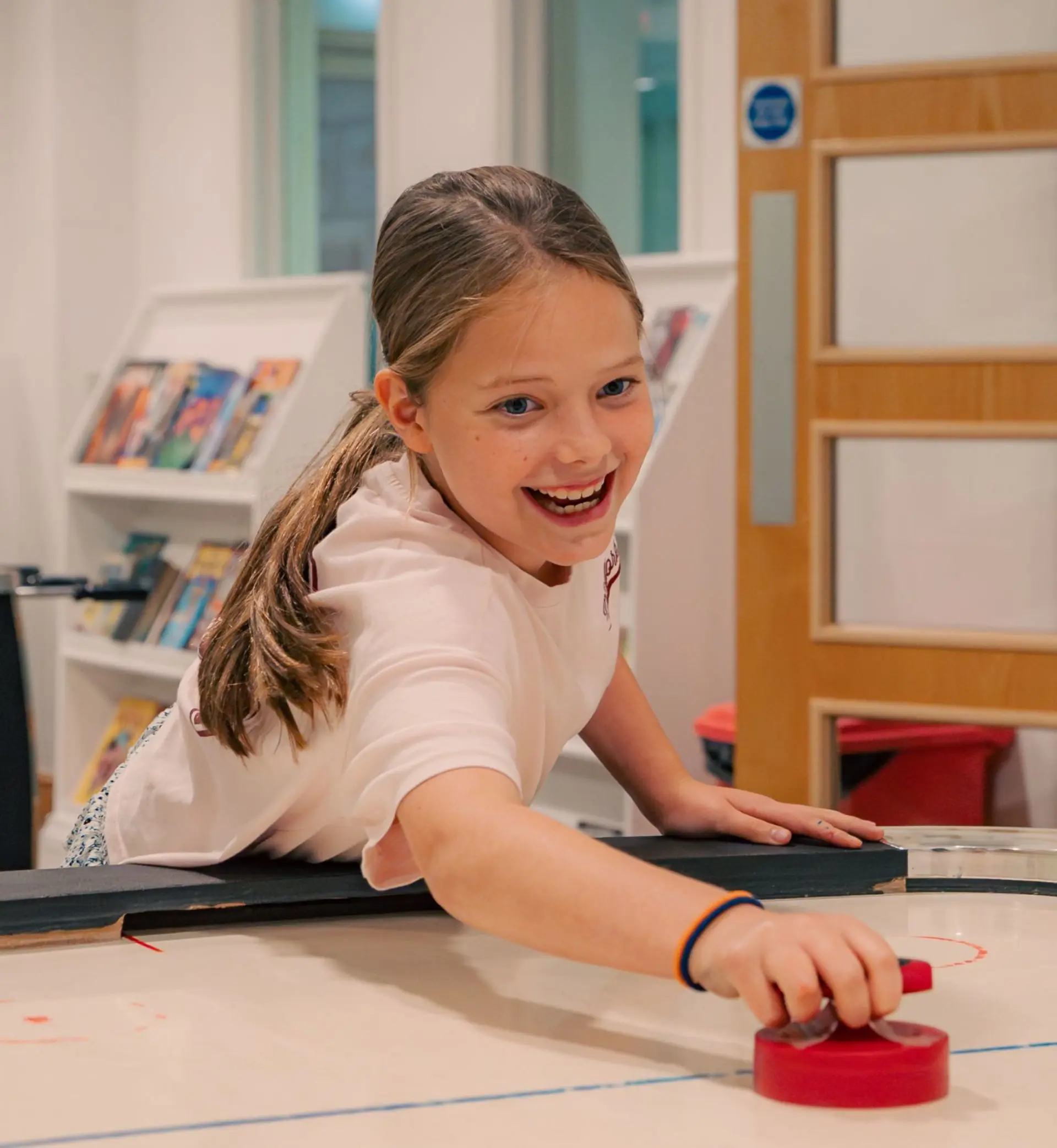 Girl playing air hockey