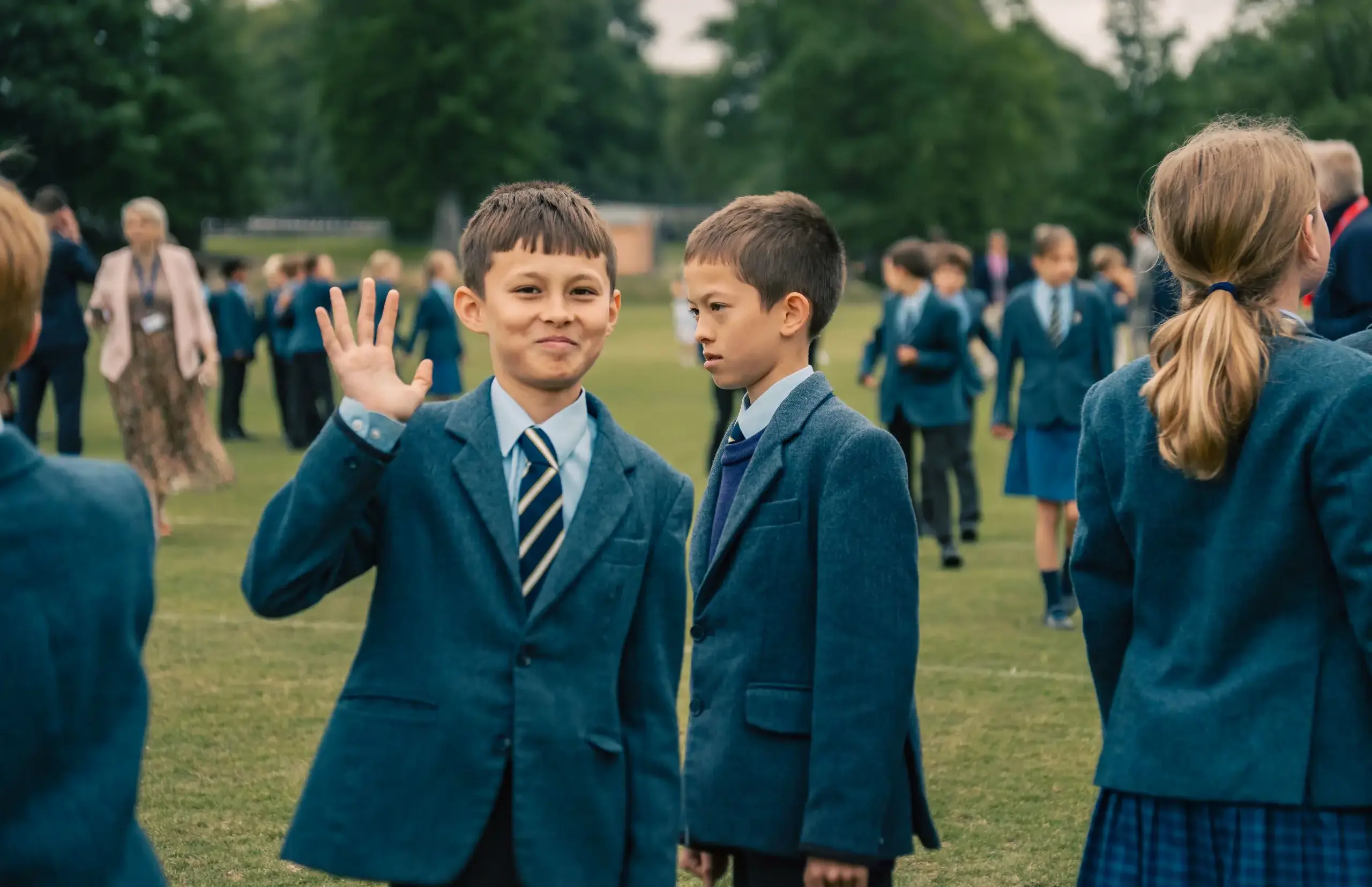 Boy waving at camera