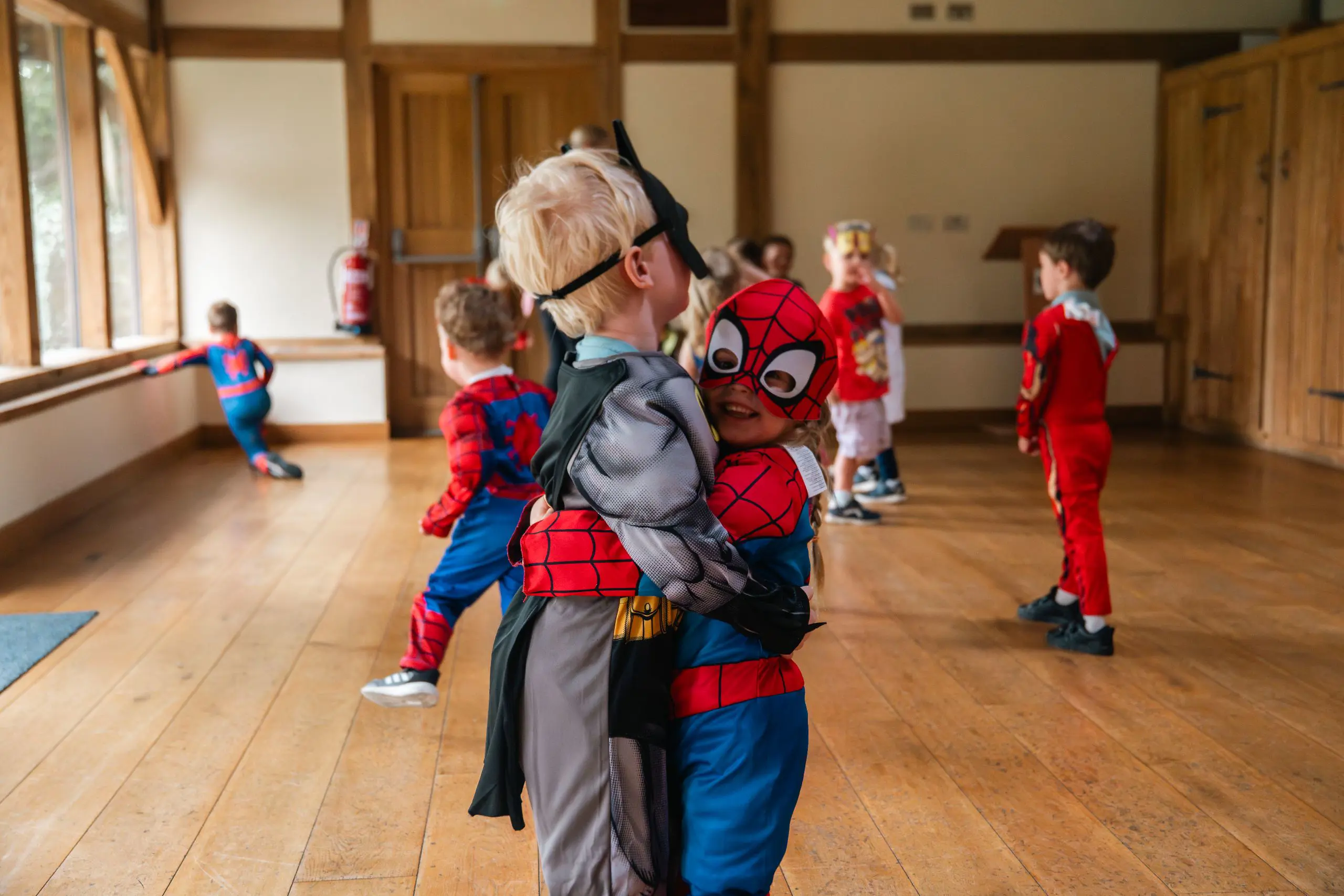 Young children in custume having fun
