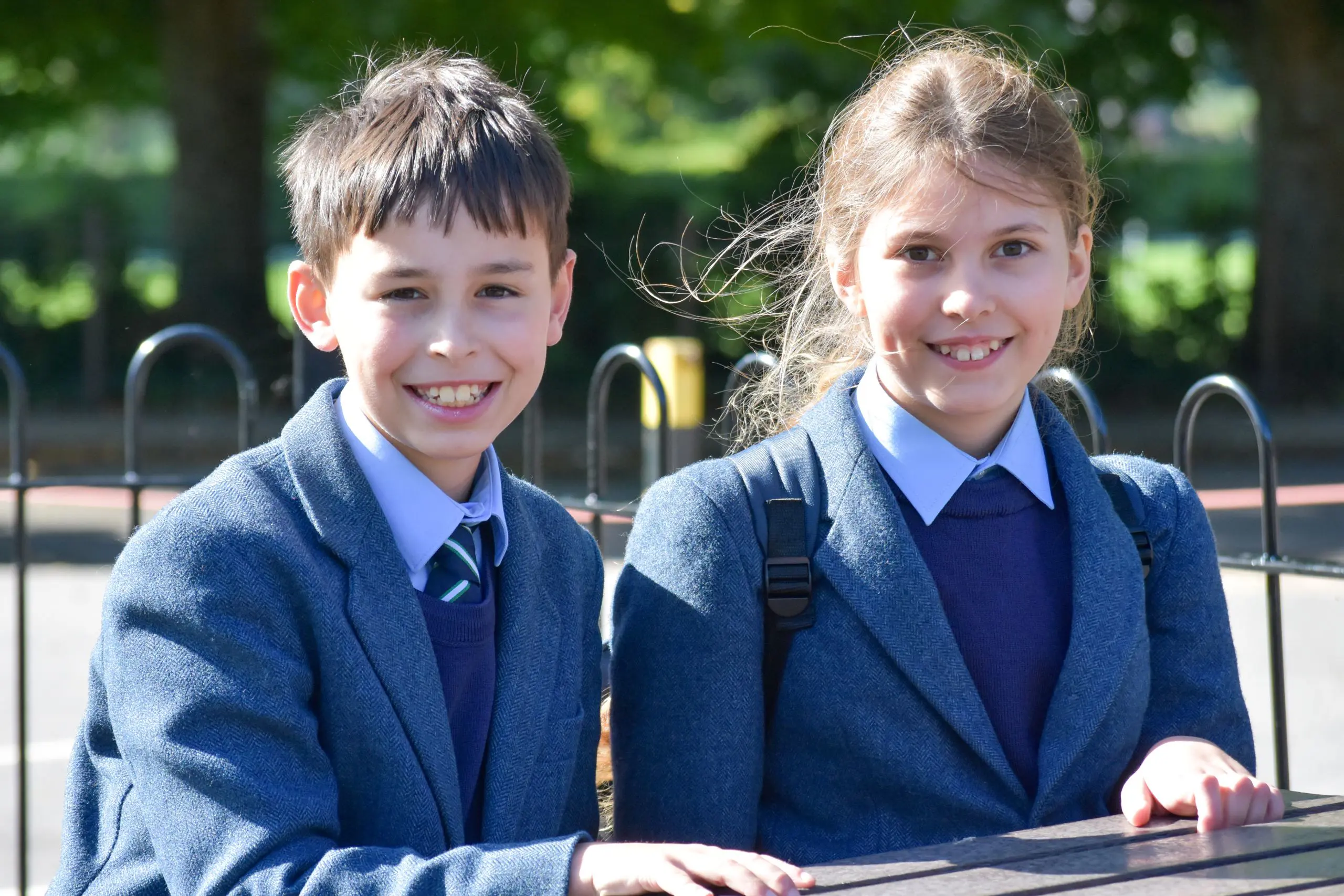 Two children sat at table outside