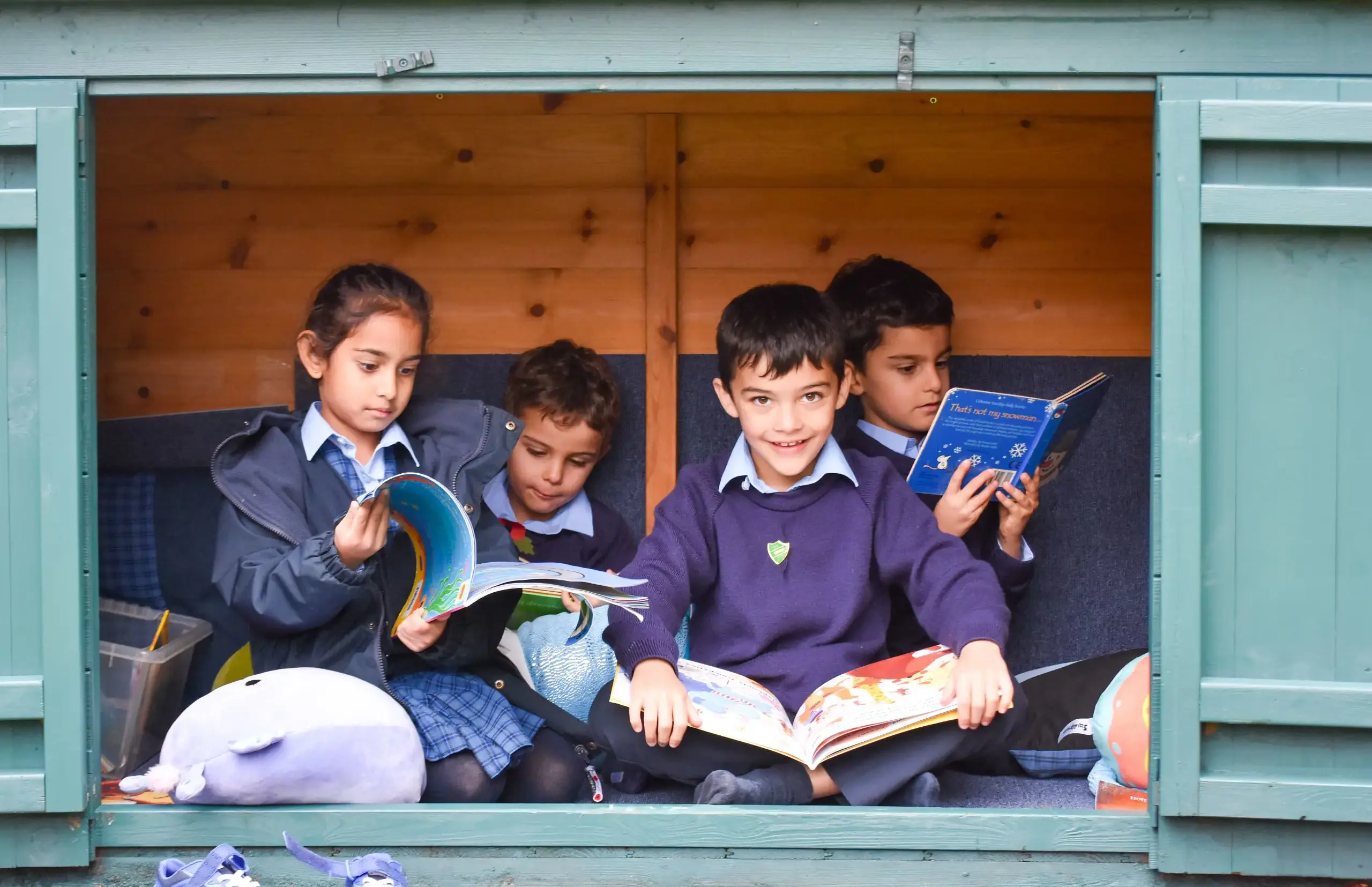 Children reading outdoors