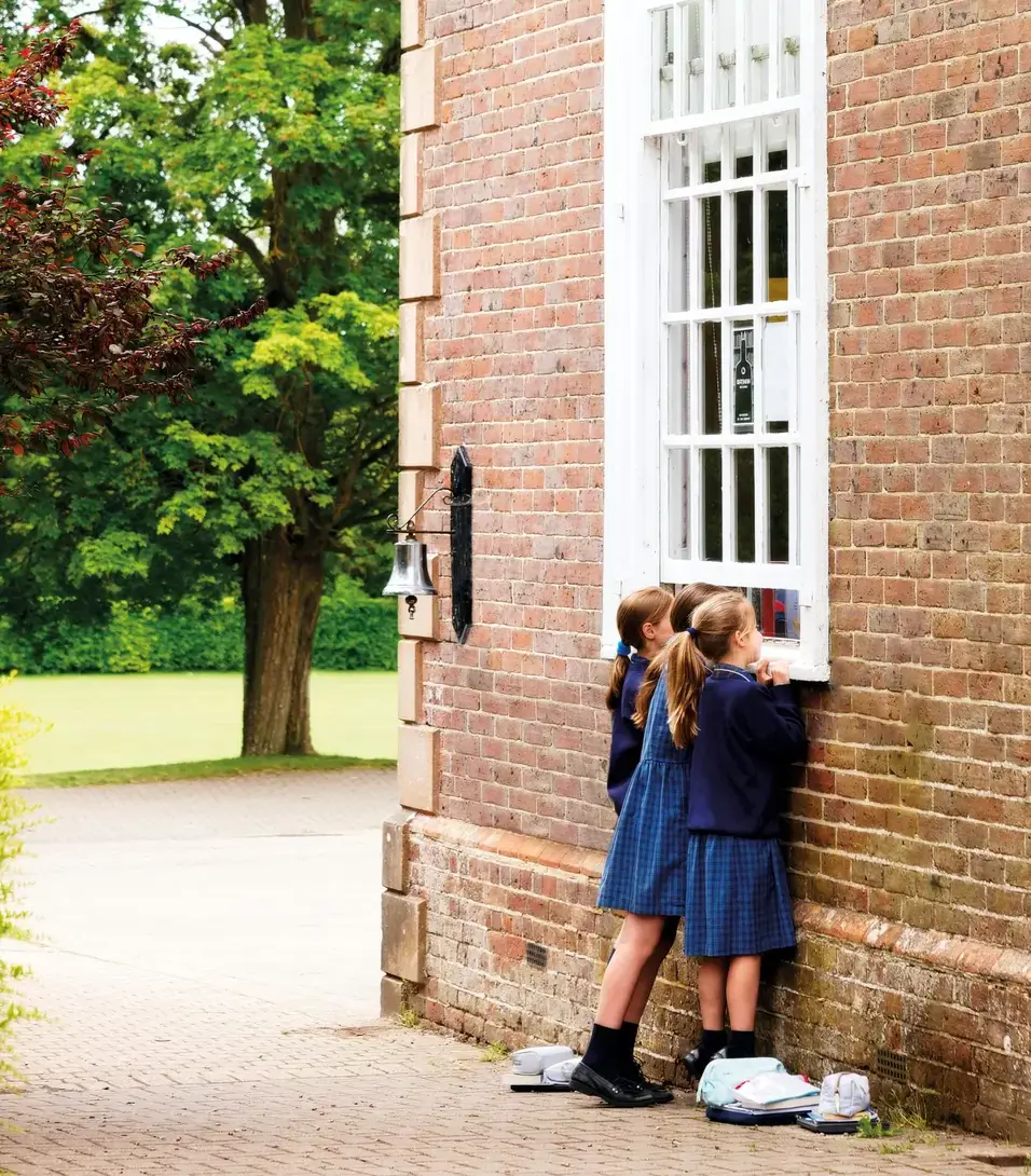 Girls peering into window