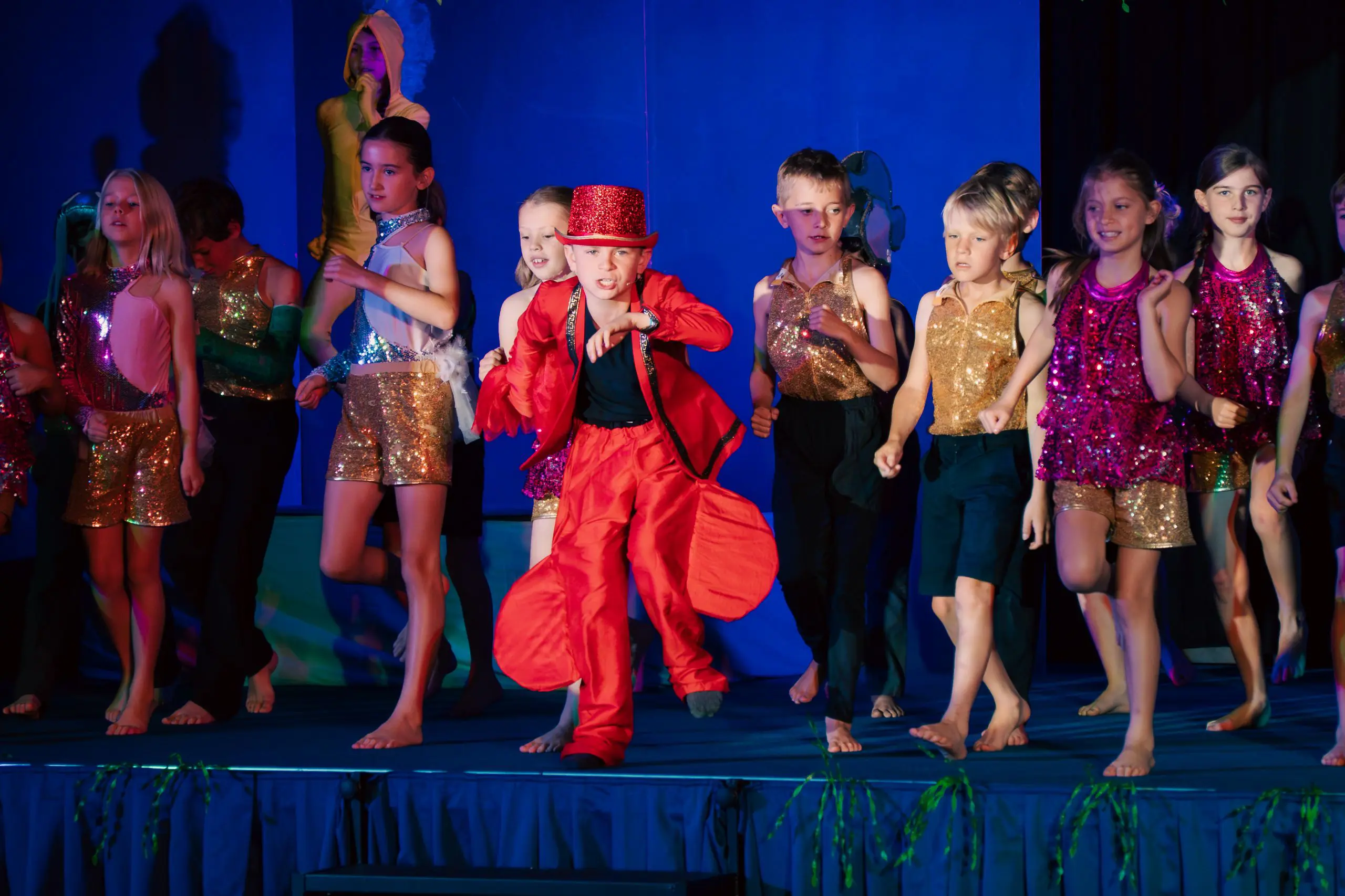 Children performing on stage in costume